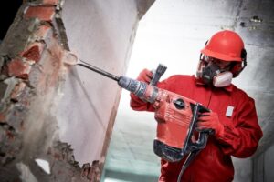Certified technician performing professional asbestos abatement services following safety protocols