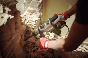 Certified technician performing professional asbestos abatement services following safety protocols